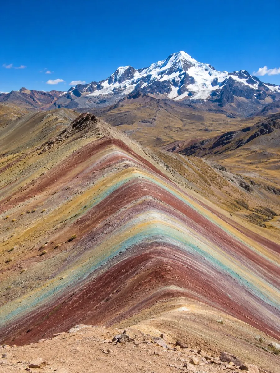 The red, mustard, green and lavender stripes of Vinicunca seen from the summit viewpoint