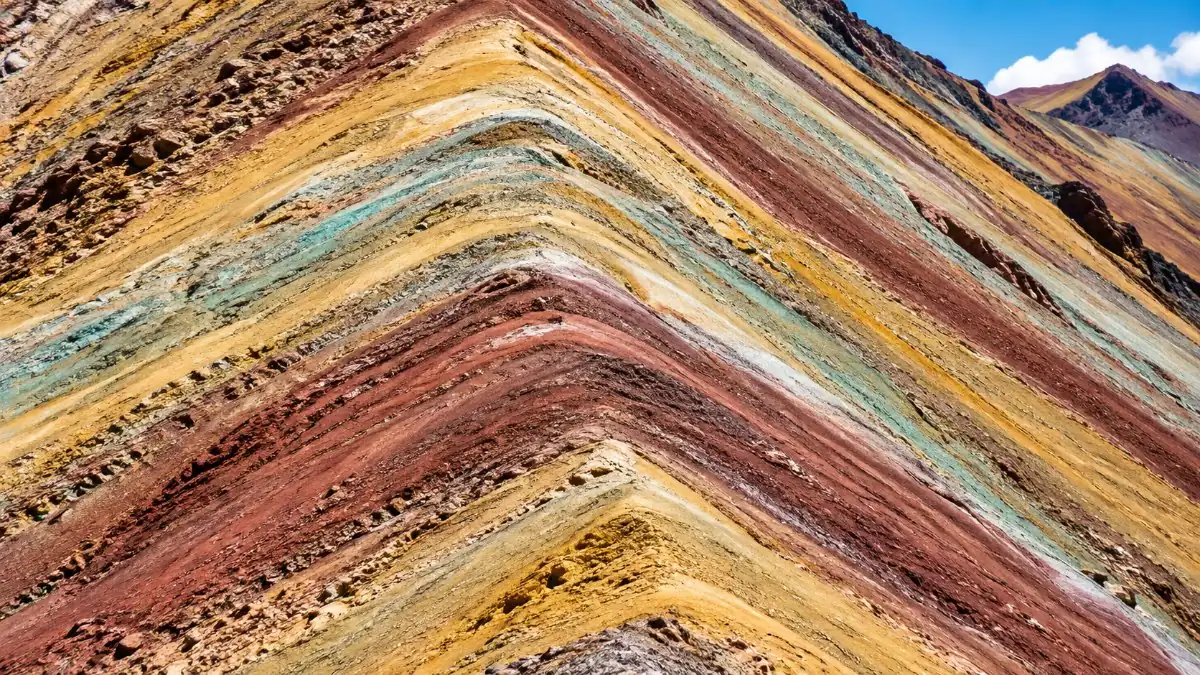 Close view of the striped slopes of Vinicunca in red, ochre, green and white bands